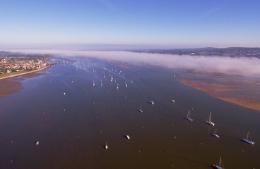aerial view of the Exe estuary in Devon, UK. Showing moored boats in evening light