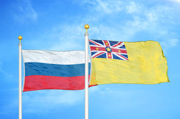 Naklejka na ściany i meble Russia and Niue two flags on flagpoles and blue cloudy sky