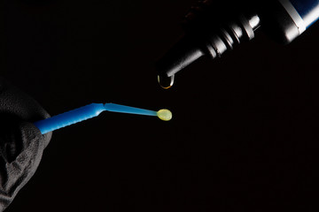 adhesive drop and dental brush