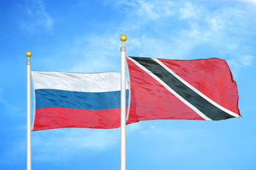 Russia and Trinidad and Tobago two flags on flagpoles and blue cloudy sky