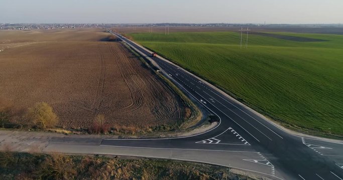 Freeway between the black earth and the green field