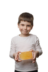 The baby holds honeycombs. boy with honey on a white background, isolate.