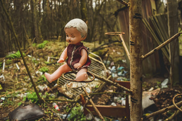 Puppet doll sitting on a tree creepy