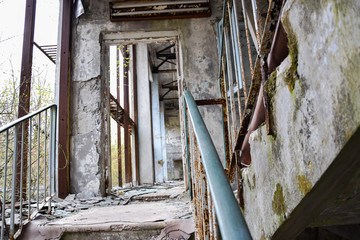 Old decayed places stair view from down looking through a door frame