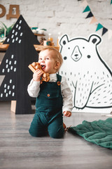 beautiful happy boy playing wooden typewriter in his room