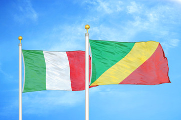 Italy and Congo  two flags on flagpoles and blue cloudy sky