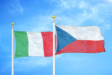 Italy and Czech Republic two flags on flagpoles and blue cloudy sky