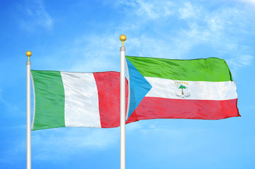 Italy and Equatorial Guinea two flags on flagpoles and blue cloudy sky