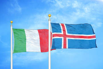 Italy and Iceland two flags on flagpoles and blue cloudy sky