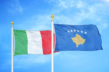 Italy and Kosovo two flags on flagpoles and blue cloudy sky