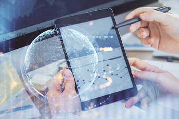 Multi exposure of man's hands holding and using a digital device and map drawing. International business concept.