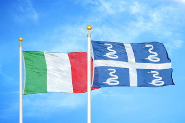 Italy and Martinique snake two flags on flagpoles and blue cloudy sky