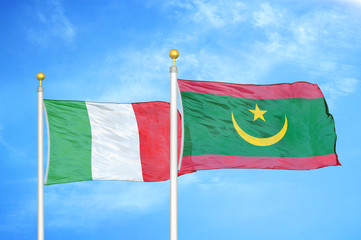 Italy and Mauritania two flags on flagpoles and blue cloudy sky