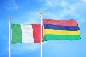 Italy and Mauritius two flags on flagpoles and blue cloudy sky