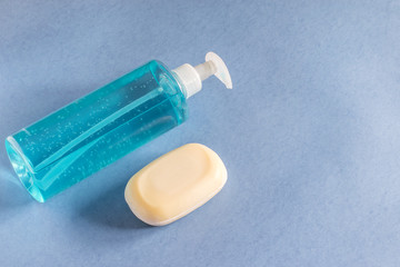 Antibacterial hand liquid sanitizer gel and disinfection soap on the blue background isolated. Personal hygiene, health care concept.