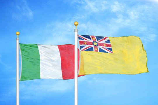 Italy and Niue two flags on flagpoles and blue cloudy sky