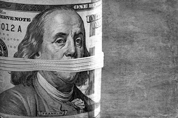 Dollars closeup.Detail of a Benjamin Franklin's portrait.Black and white photo .