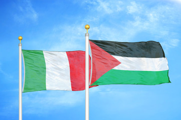 Italy and Palestine two flags on flagpoles and blue cloudy sky