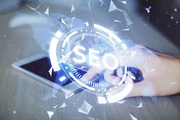 Double exposure of SEO sketch hologram and woman holding and using a mobile device.