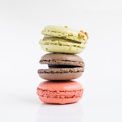 French colorful macarons. Three desserts isolated close up photo.