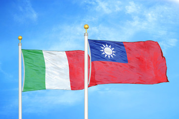 Italy and Taiwan two flags on flagpoles and blue cloudy sky