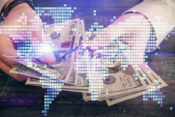 Multi exposure of financial theme drawing hologram and USA dollars bills and man hands. Business concept.
