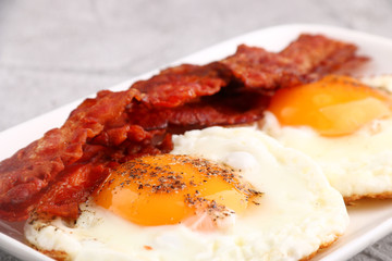 fried egg with bacon on plate. breakfast concept. close up