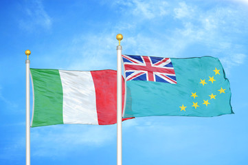 Italy and Tuvalu two flags on flagpoles and blue cloudy sky