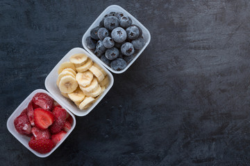 Fototapeta na wymiar Mixed Healty Fresh Frozen Fruits Banana Strawberry Blueberry