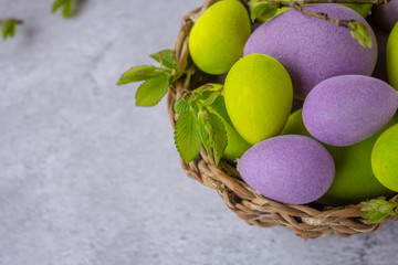 Obraz na płótnie Canvas easter green and purple eggs with rabbit on a light surface