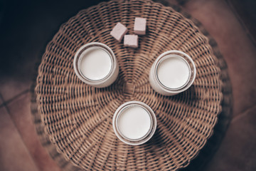 three glass jars of milk and sweets
