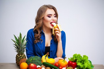 The concept of healthy eating and diet girl holding vegetables on background white wall