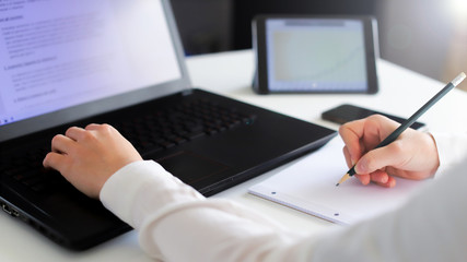 Close up of a woman hands typing on a keyboard. Distance learning, education online. Online working from home, business and technology concept
