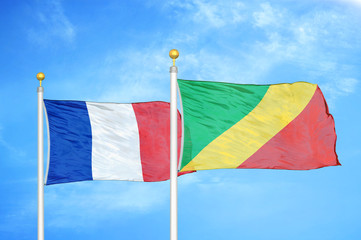 France and Congo  two flags on flagpoles and blue cloudy sky