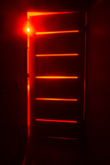 Bright red light from the room through the door. Abstract mystical glowing exit