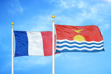 France and Kiribati two flags on flagpoles and blue cloudy sky