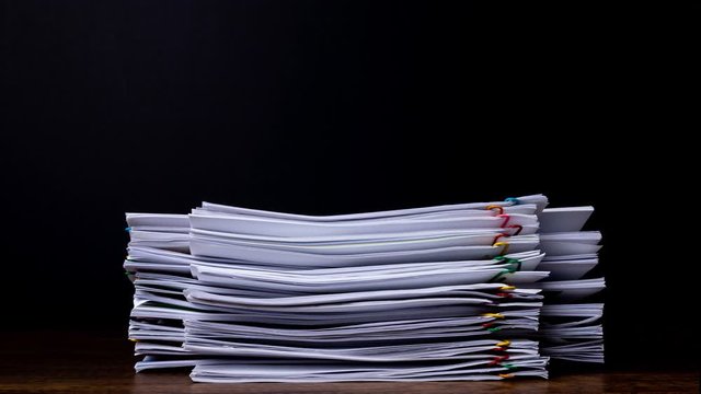 Stack overload document report paper with colorful paperclip place and copy space, business concept footage paperless used &ndash; 4K Stop motion.