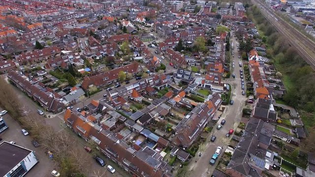 Aerial drone view of a nice neighbourhood with red rooftops in the Netherlands 4K