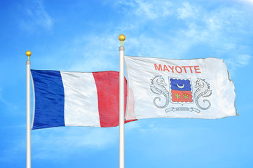 France and Mayotte two flags on flagpoles and blue cloudy sky