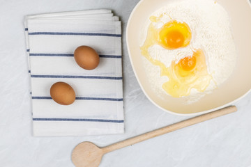 Top view of smashed eggs in flour ready for creating dough