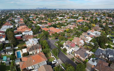 Low level aerial panoramic view of the Melbourne residential suburb of Preston, with the CBD in the background