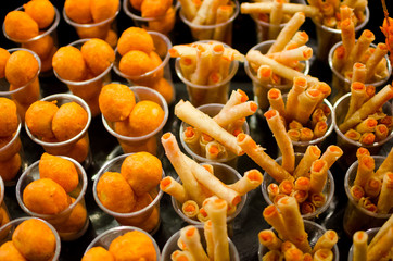 Assorted street food in bright orange colors