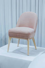Contemporary armchair, comfortable wooden with velor upholstery in pink powdery color.
