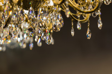Close up on the crystal of chandelier. Dark background with empty space