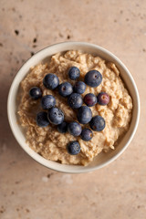Overhead Closeup of Blueberries on Porridge in a Bowl