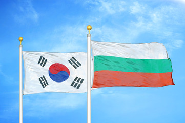 South Korea and Bulgaria  two flags on flagpoles and blue cloudy sky