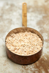 Uncooked Porridge or Oatmeal in Copper Pot
