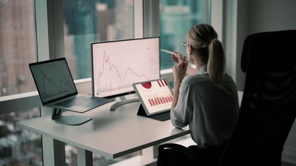 Experienced female broker working with trade stock exchange checking financial chart from market block chain connected to corporate wifi in office interior, skilled woman with electronic stylus 
 - Powered by Adobe