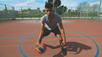 Black athlete dribbling and shooting basketball ball