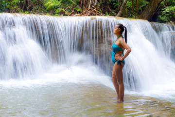 Woman in swimsuit stand at Huai Mae Khamin waterfall and natural
